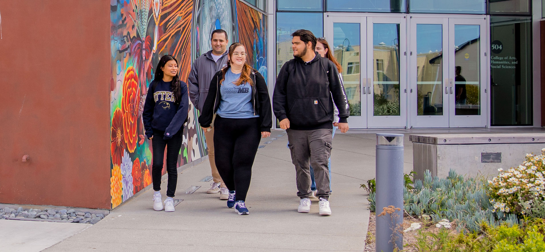 students walking outside the College  of Arts, humanities and social science  building