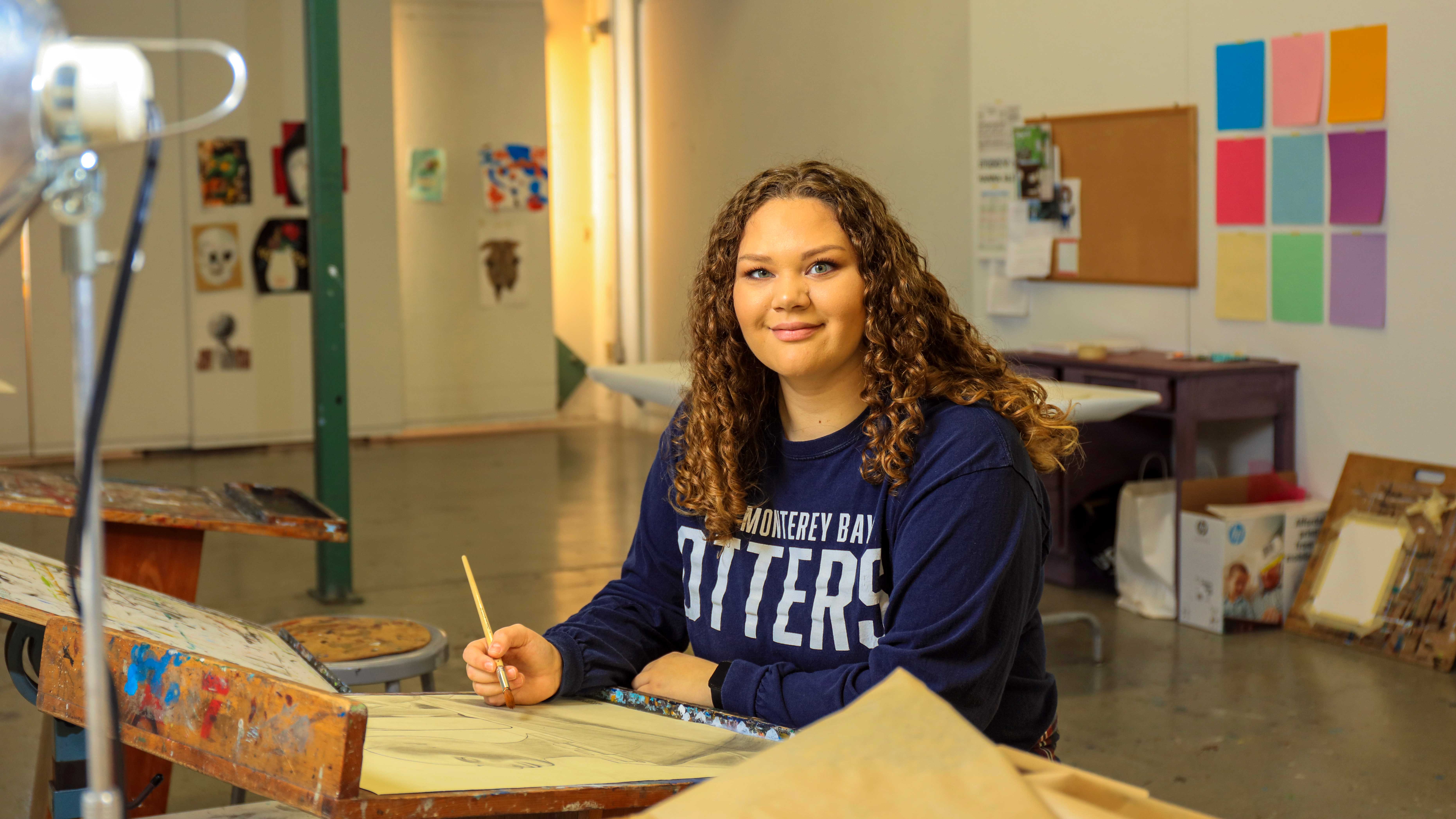 student painting in an art class