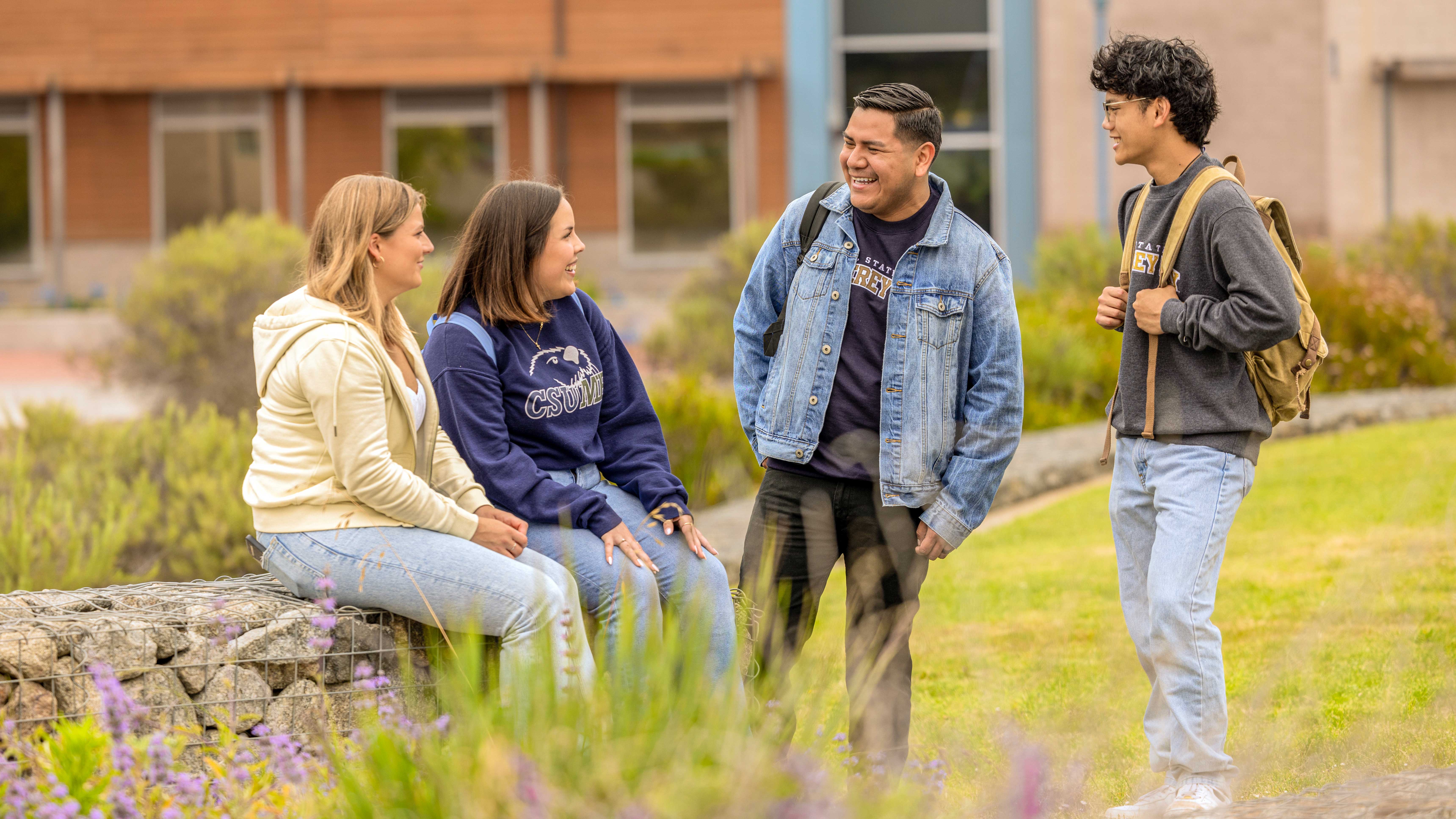 four students outside talking