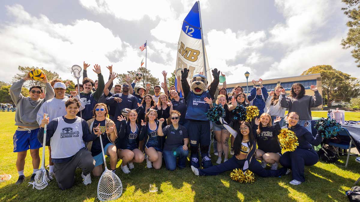 CSUMB athletes and a mascot posing for a group photo