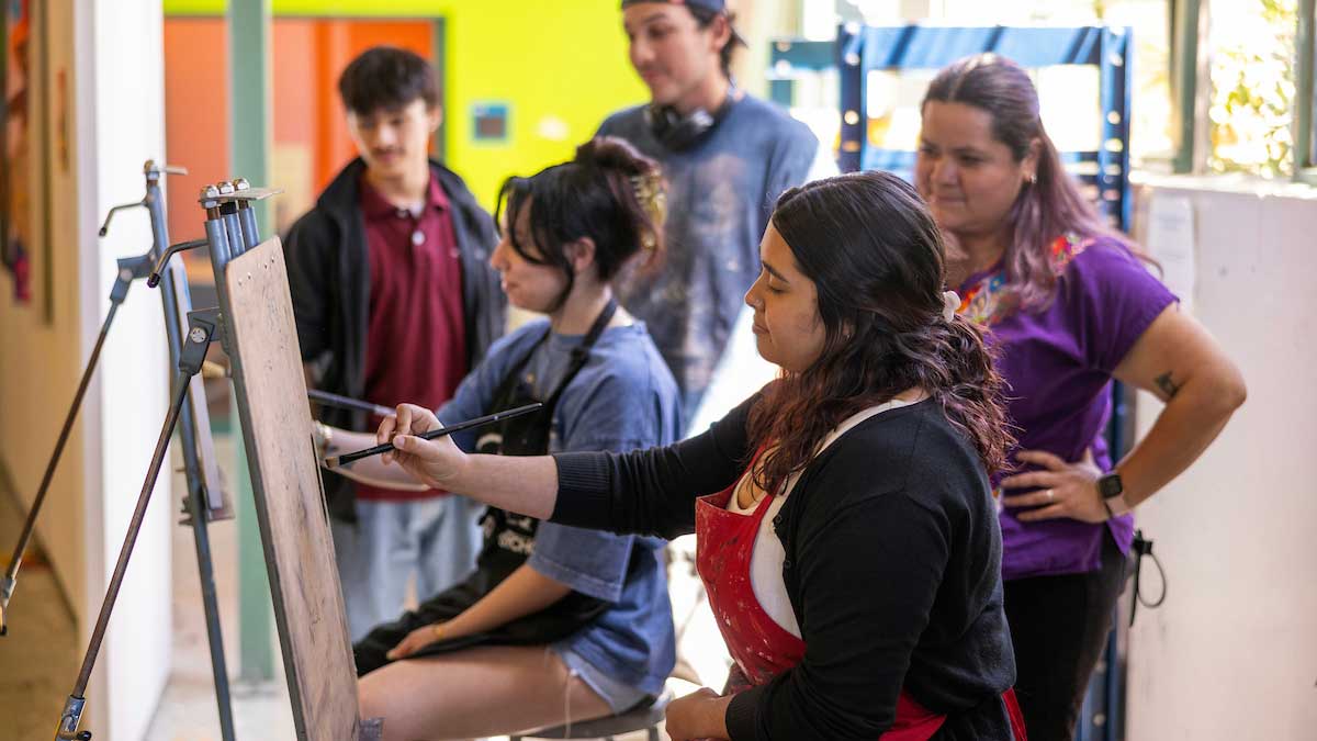 students painting in an art class