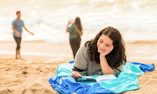 student studying on the beach